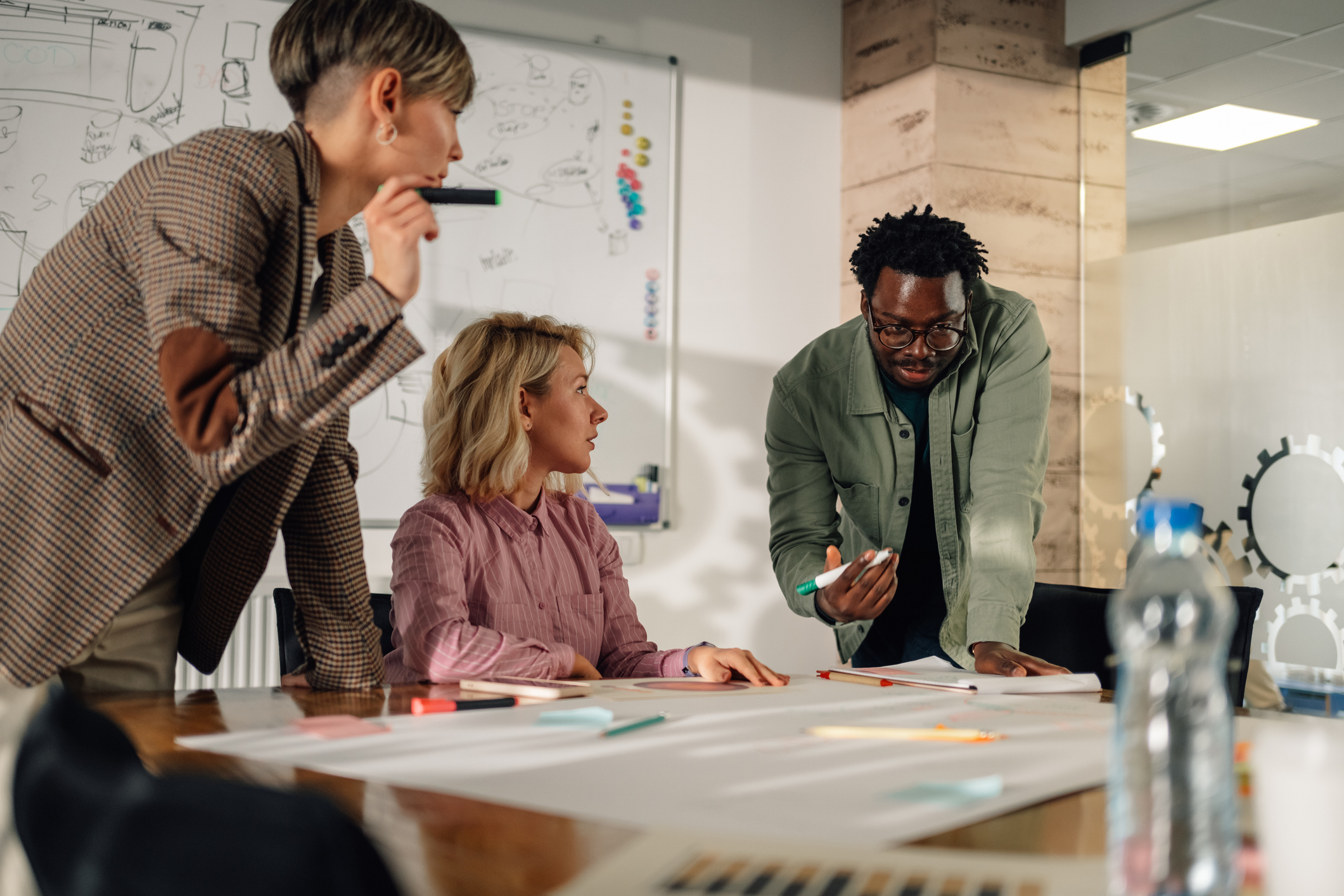 Marketing team analyzing diagrams and graphs during a meeting
