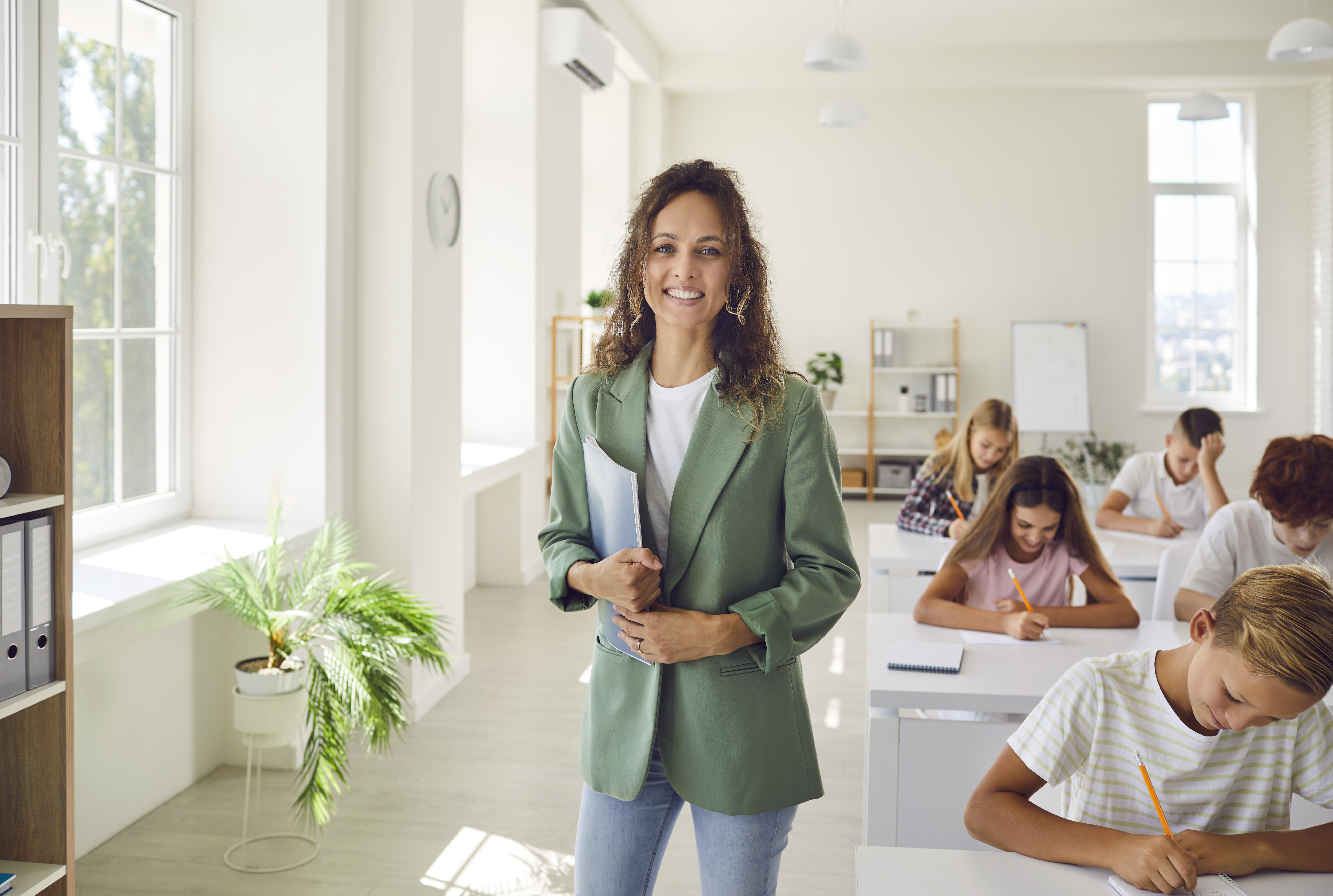 Teacher standing in a classroom with students
